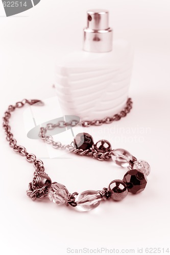 Image of necklace and parfume bottle