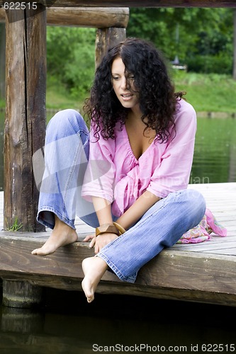 Image of  woman sitting near the water