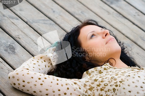 Image of woman lying on wooden floor
