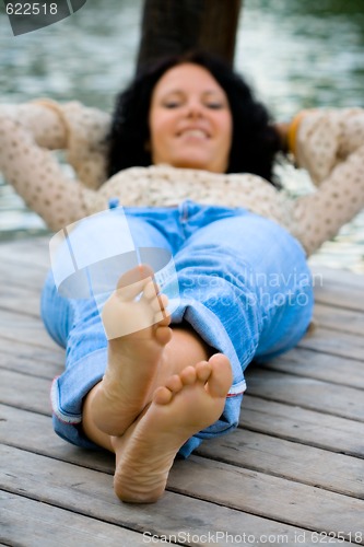 Image of woman lying near the river