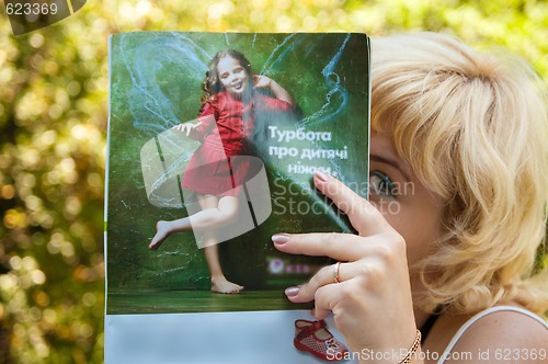 Image of girl reading magazine