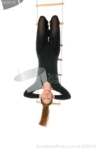 Image of Woman hanging on a rope ladder