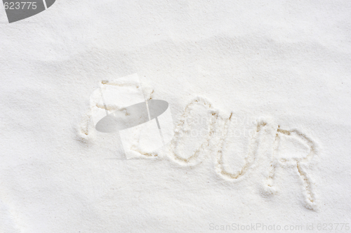 Image of Word "flour" handwritten in flour