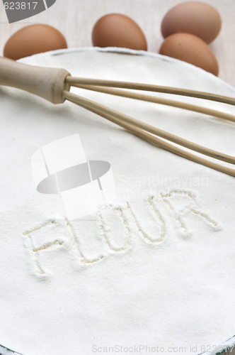 Image of Word "flour" handwritten in flour