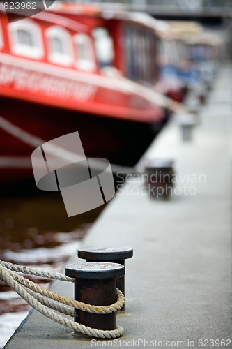 Image of boats docked in harbor bollards