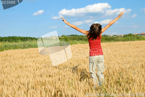 Image of Happy girl jumping in wheat field