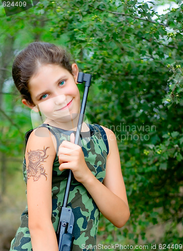 Image of Girl with gun in wood