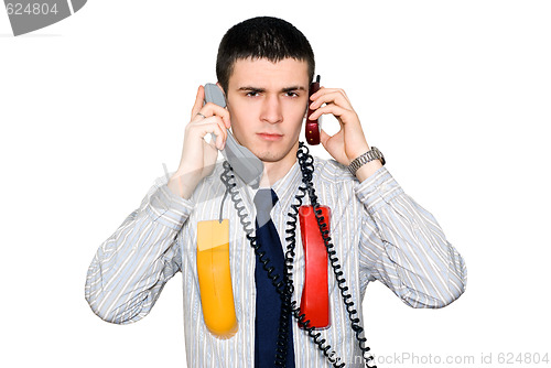 Image of The young man speaks by two phone