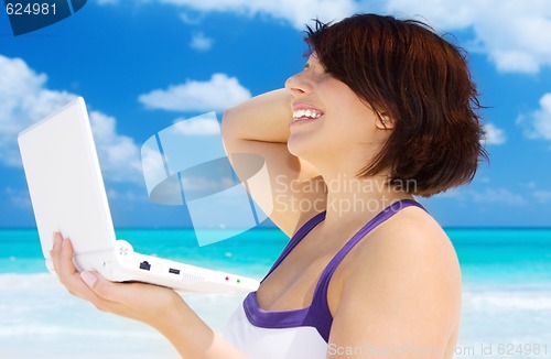 Image of woman with laptop computer on the beach