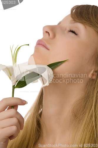 Image of young girl smelling lily