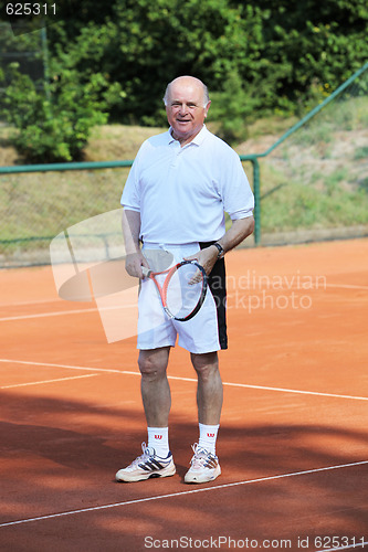 Image of a aktive senior is playing tennis