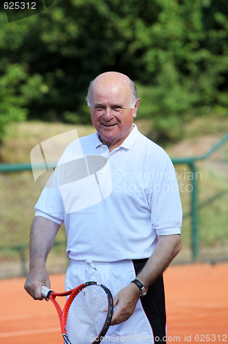 Image of a aktive senior is playing tennis