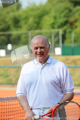 Image of a aktive senior is playing tennis