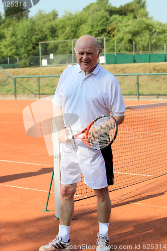 Image of a aktive senior is playing tennis