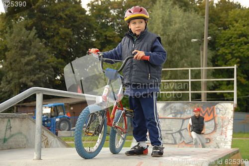 Image of Young boy rides bicycle