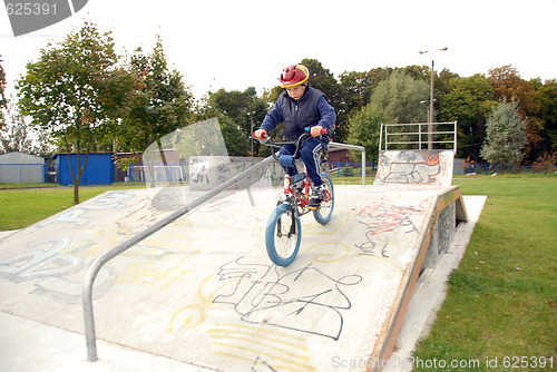 Image of Young boy rides bicycle