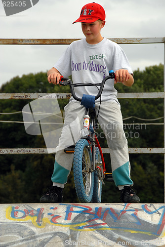 Image of Young boy rides bicycle