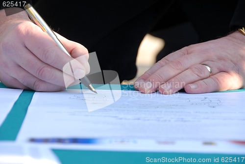 Image of Businessman is signing a contract
