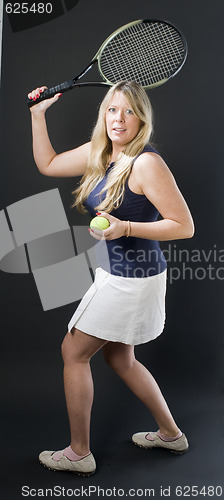 Image of woman practicing tennis stroke