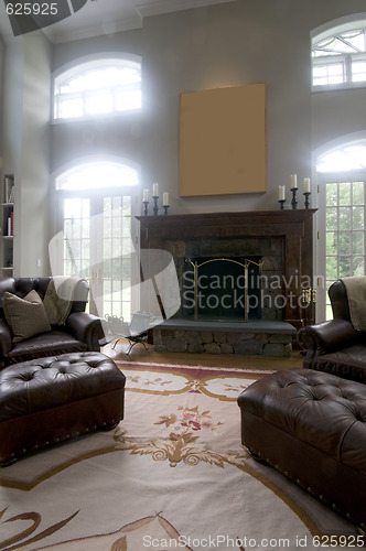 Image of large living room with leather chairs and fireplace