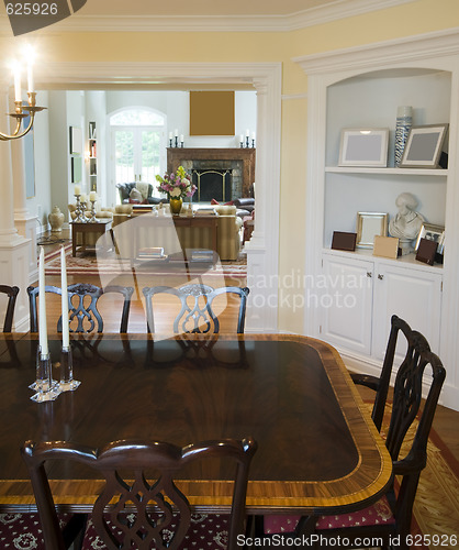 Image of formal dining room and luxurious living room in mansion