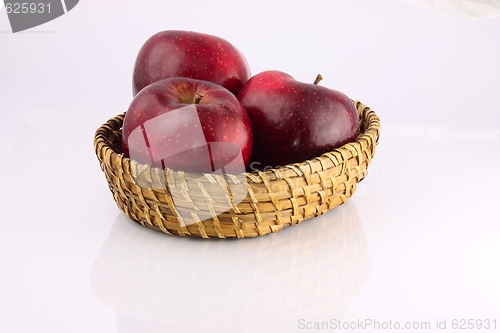 Image of Red apples in a wicker plate
