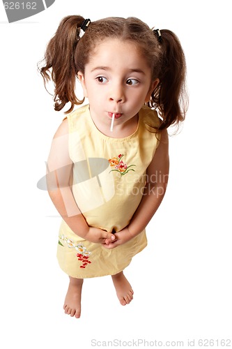 Image of Cute girl sucking on a lollipop candy