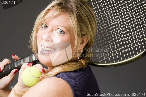 Image of woman practicing tennis stroke