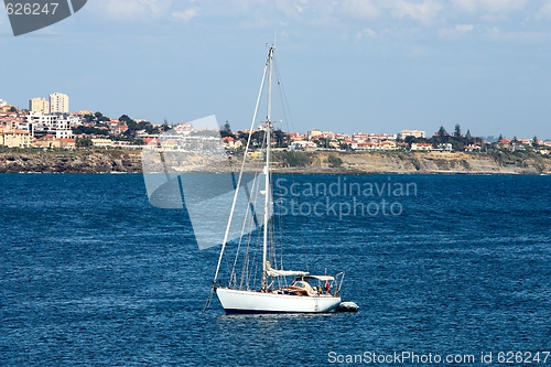 Image of The large, beautiful yacht in the light-blue sea.