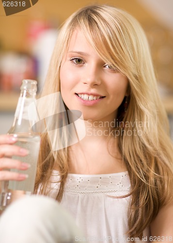 Image of lovely teenage girl with bottle of water