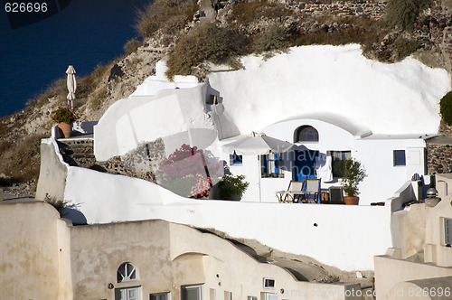 Image of  villa built into volcanic cliffs in cyclades architecture oia i