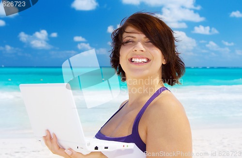 Image of woman with laptop computer on the beach