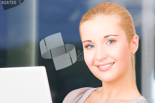 Image of happy businesswoman with laptop computer