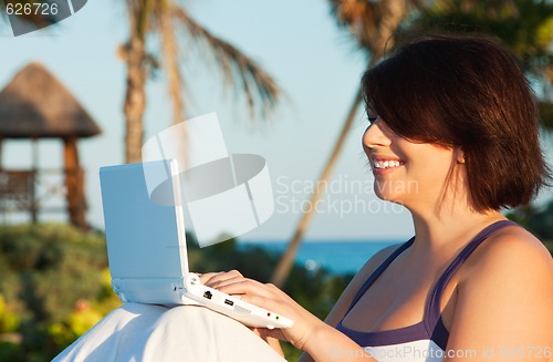 Image of lovely woman with laptop computer