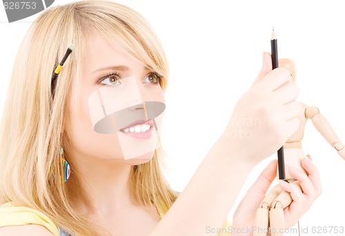 Image of happy teenage girl with wooden model dummy