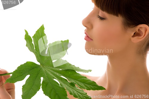 Image of woman with green leaf