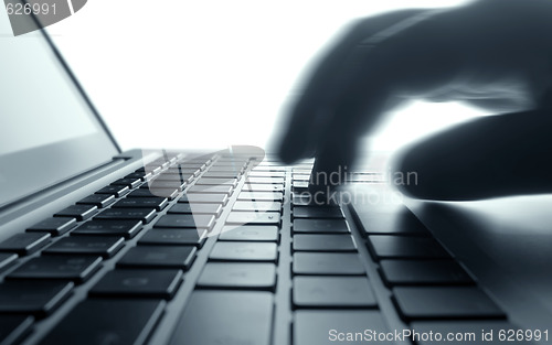 Image of Typing on laptop keyboard.