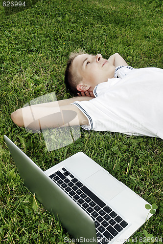 Image of Boy lying on grass 