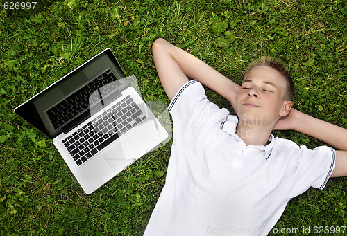 Image of Boy lying on grass