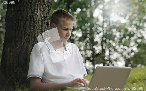 Image of Young man using laptop i