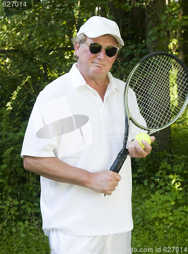 Image of middle age senior tennis player male demonstating stroke