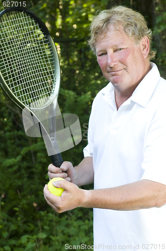 Image of  middle age senior tennis player male demonstating stroke