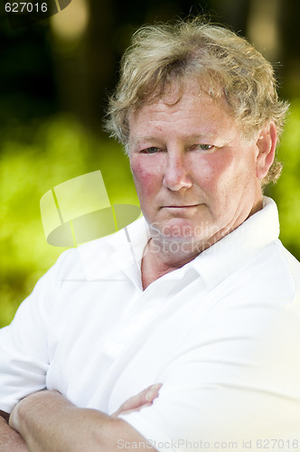 Image of serious middle age senior tennis player male