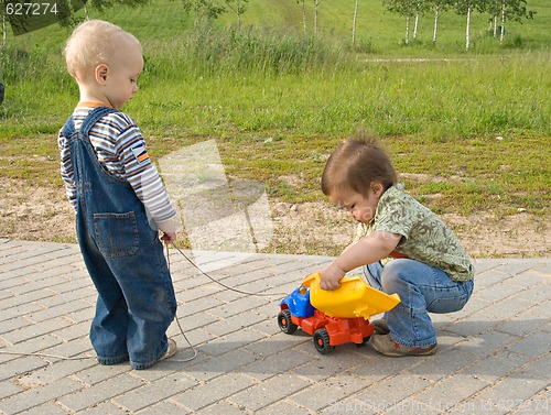 Image of Children with a toy truck