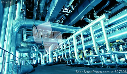 Image of Pipes, tubes, machinery and steam turbine at a power plant