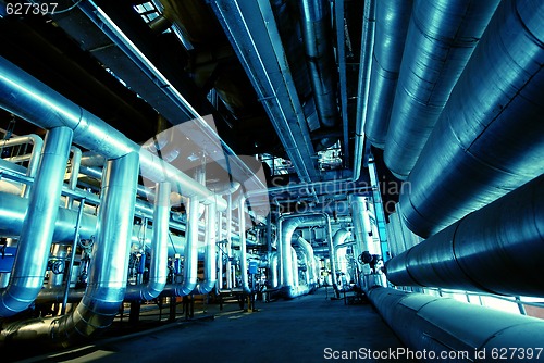 Image of Pipes, tubes, machinery and steam turbine at a power plant