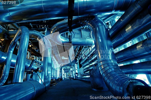 Image of Pipes, tubes, machinery and steam turbine at a power plant