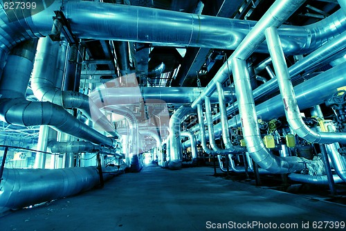 Image of Pipes, tubes, machinery and steam turbine at a power plant