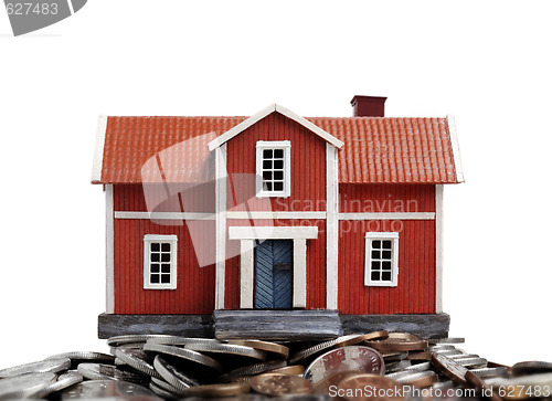Image of Model of house on pile of coins
