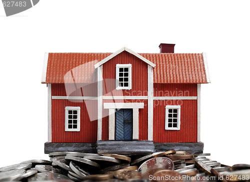 Image of Model of house on pile of coins